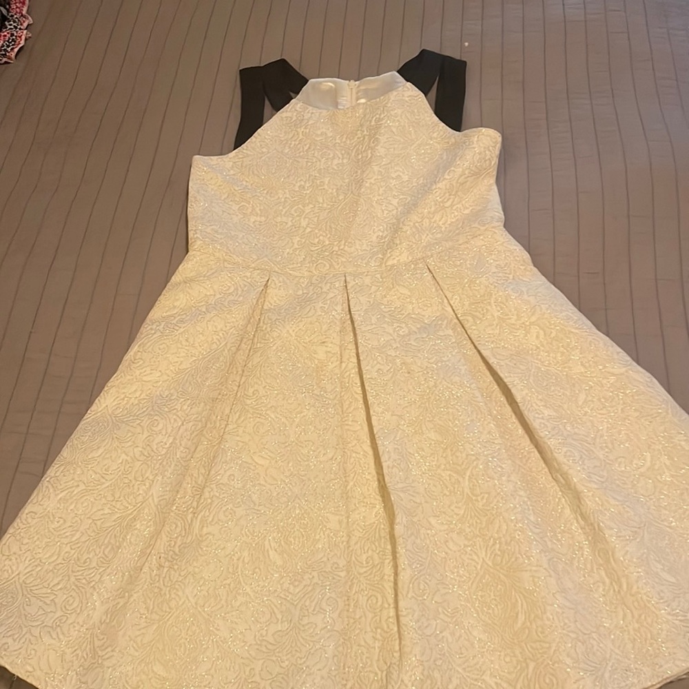 White dress with silver stitching.